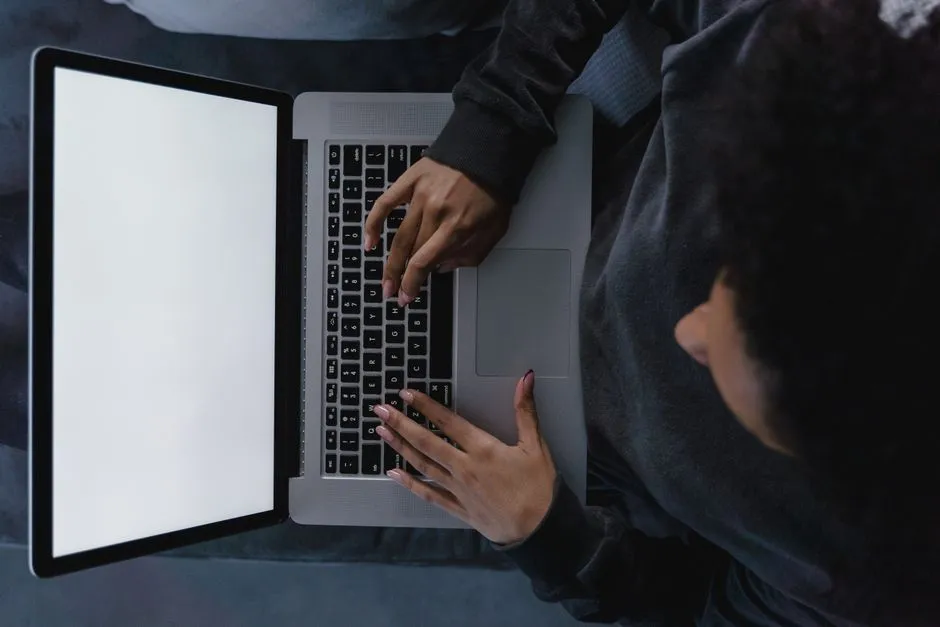 Person typing on a laptop keyboard